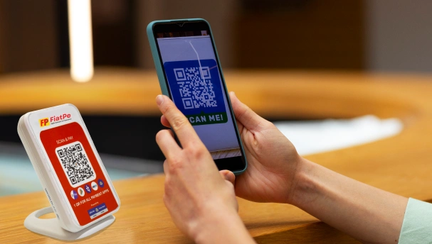 An illustrated banner showing the FiatPe smart speaker labeled with “powered by FiatPe,” set against a dynamic backdrop of power waves and icons, highlighting the device’s reliable connectivity and instant voice payment notifications for merchants.